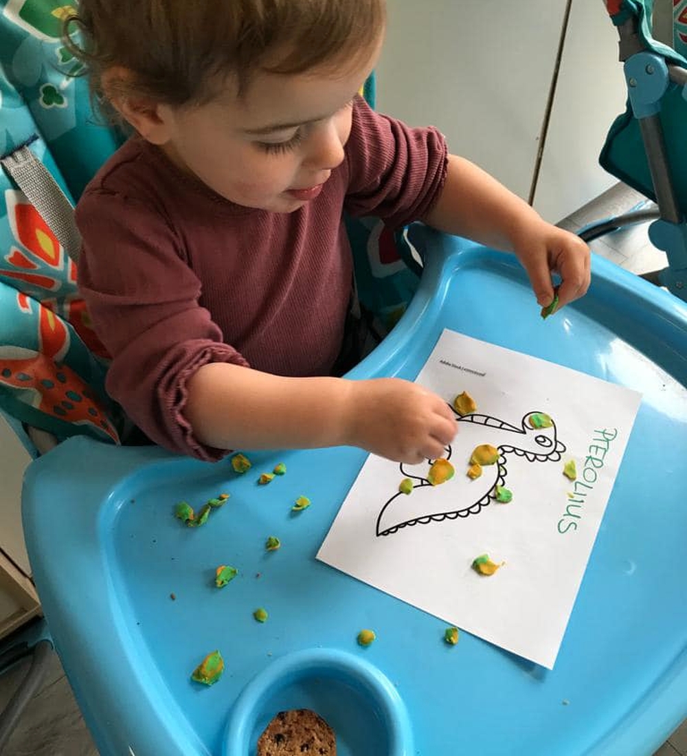 Dziecko wykonuje pracę plastyczna dinozaura Dziecko wykonuje pracę plastyczna dinozaura
